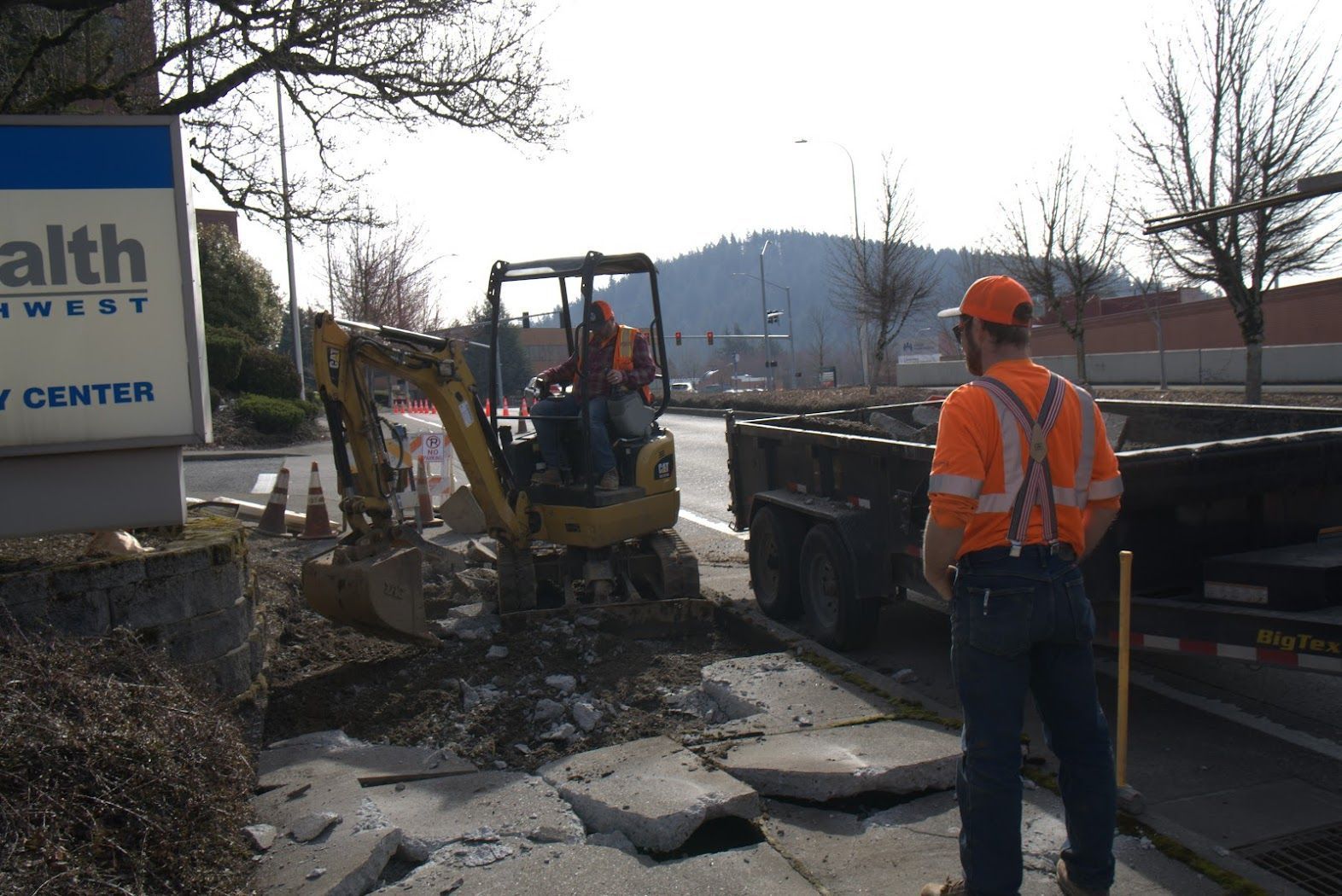 A man standing in front of a sign that says health west