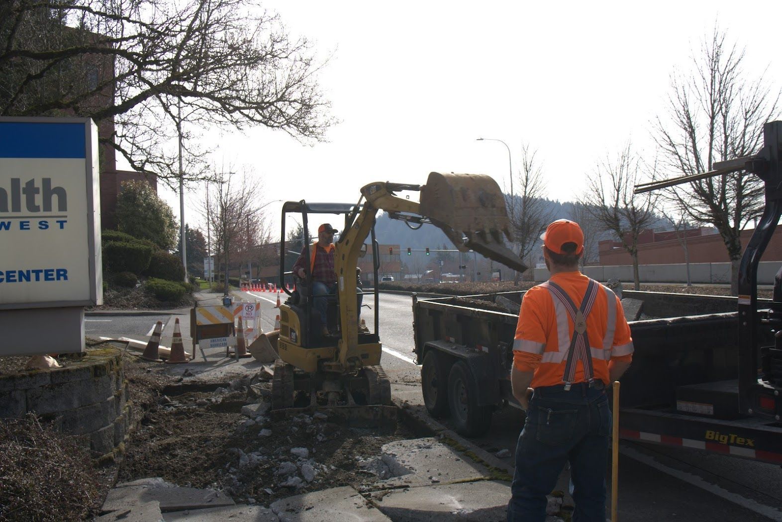 A man standing in front of a health center sign