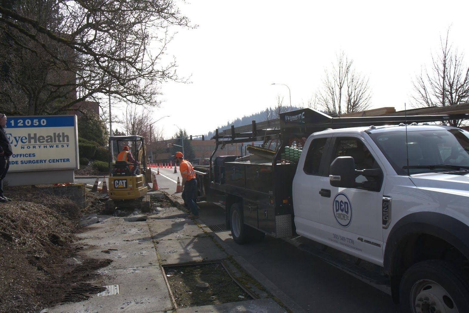 A white truck is parked in front of a sign that says eye health