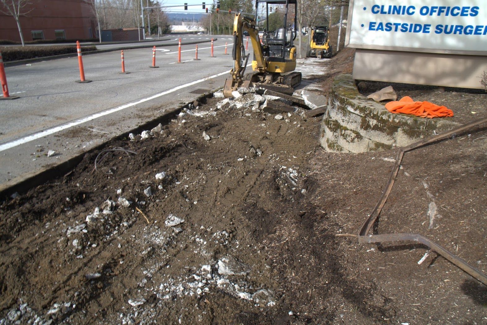 A construction site with a sign that says clinic offices eastside surgeons