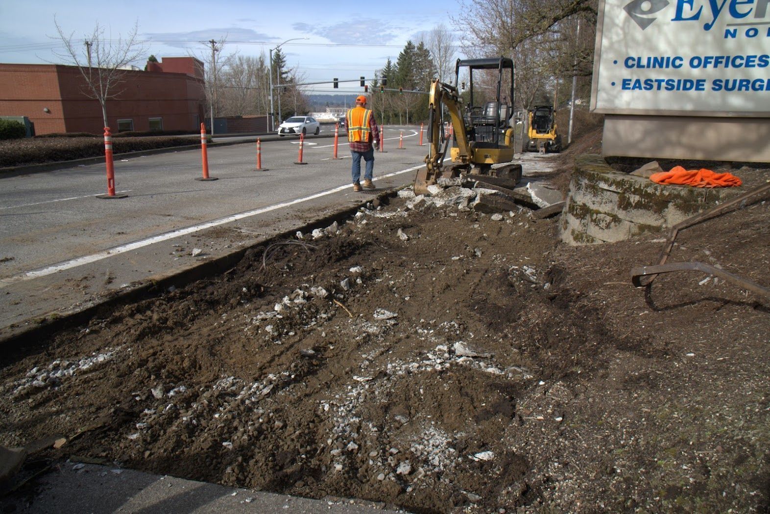 A man is standing next to a sign that says clinic offices