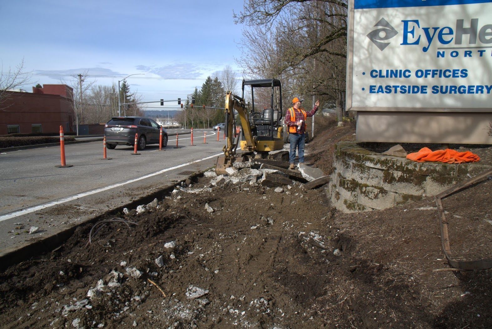 A man is standing in front of a sign that says eye hospital