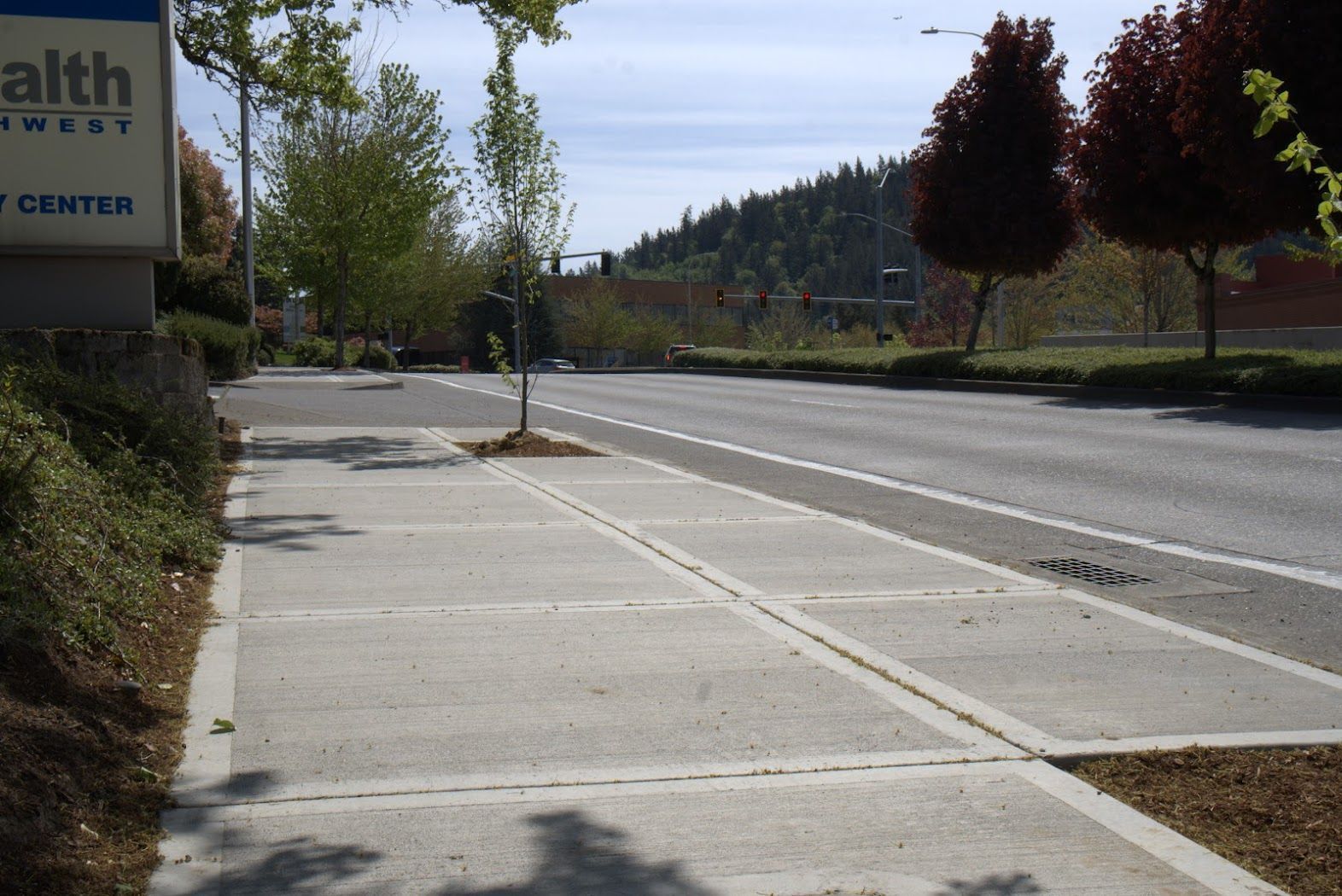 A sidewalk in front of a sign that says health center