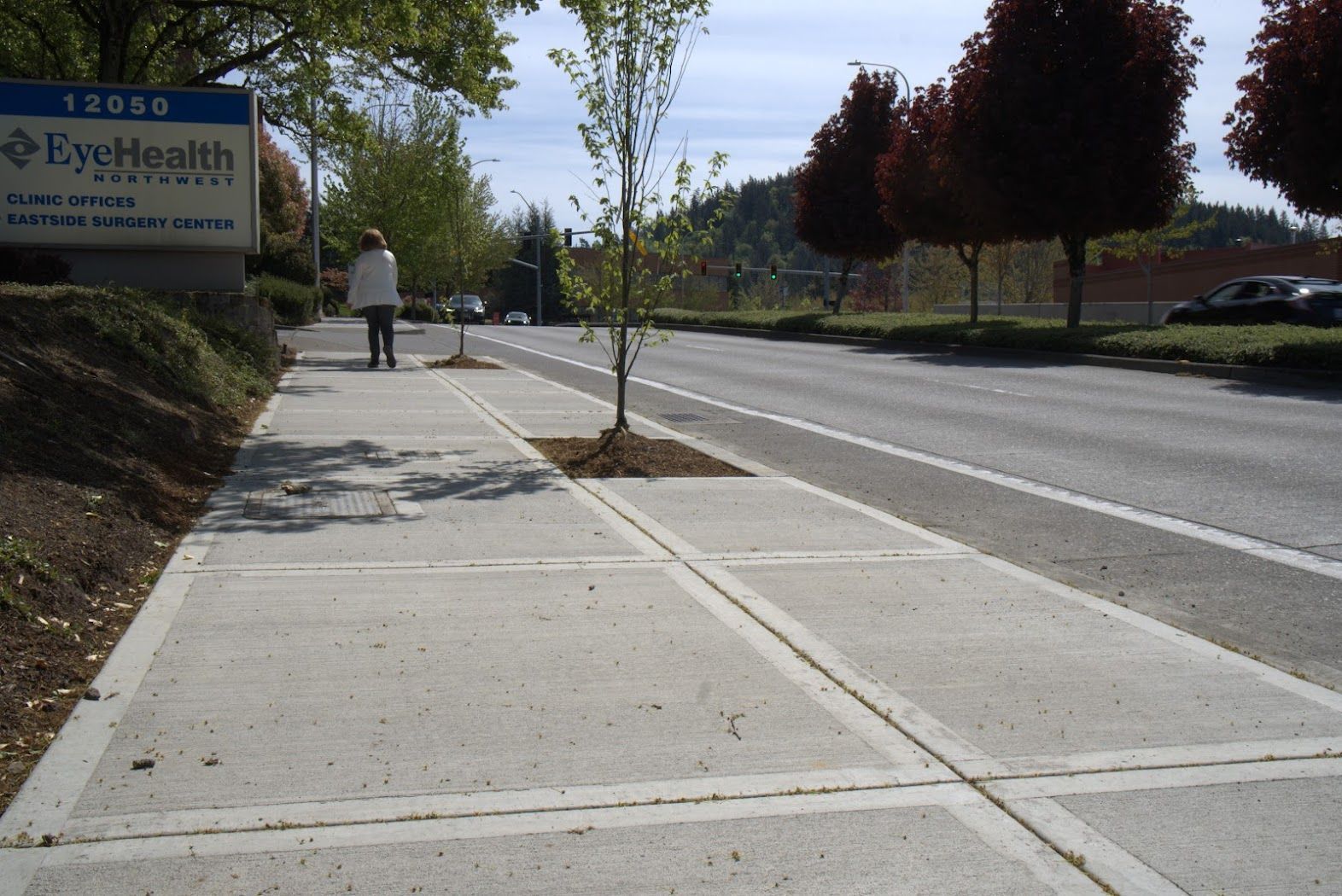 A sidewalk with a sign that says evehealth on it