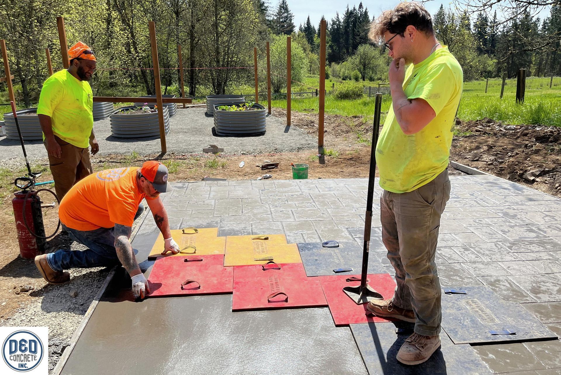 A group of construction workers are working on a concrete floor.