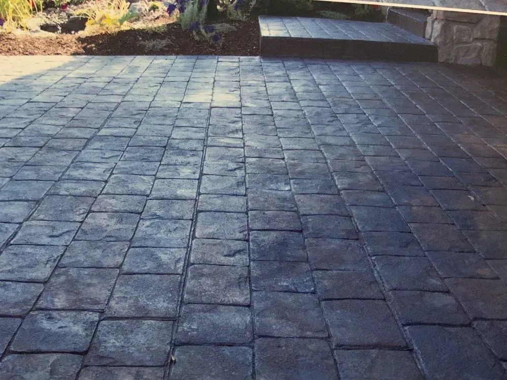 A brick driveway with steps leading up to it
