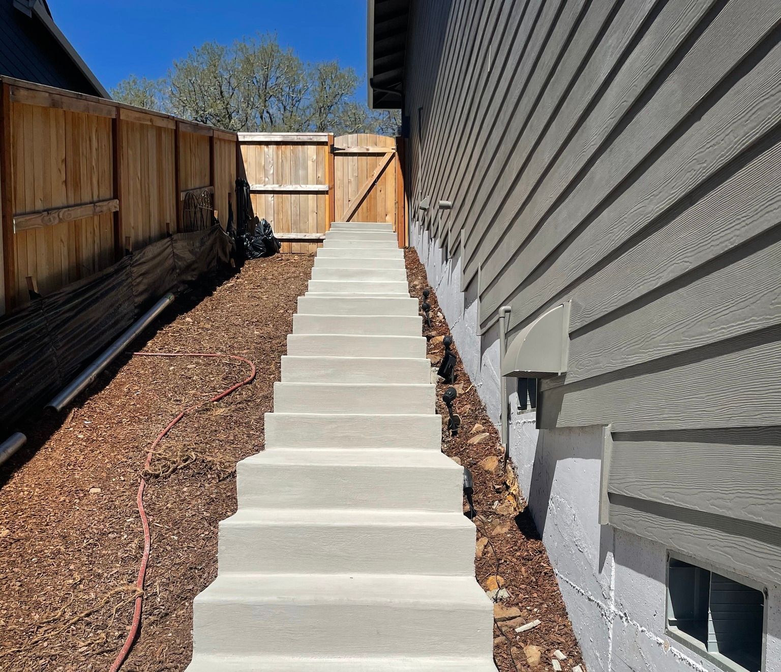 A set of concrete stairs leading up to a house