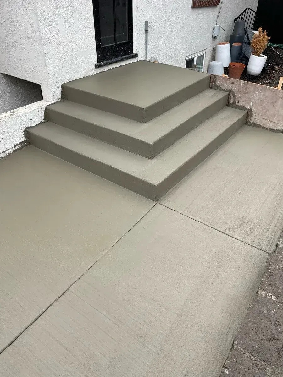 A set of concrete steps leading up to a house.