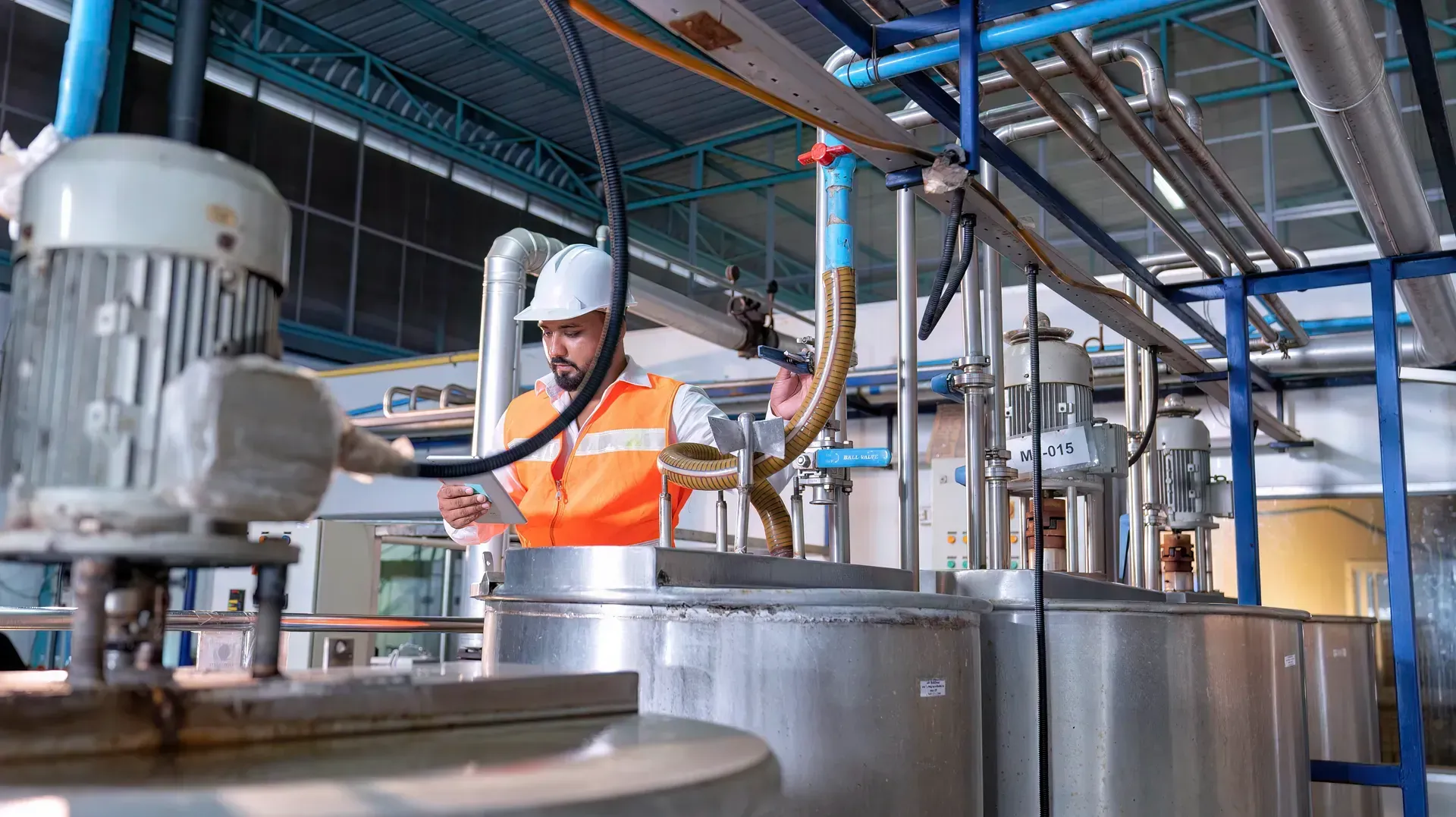 A man is working on a machine in a factory.