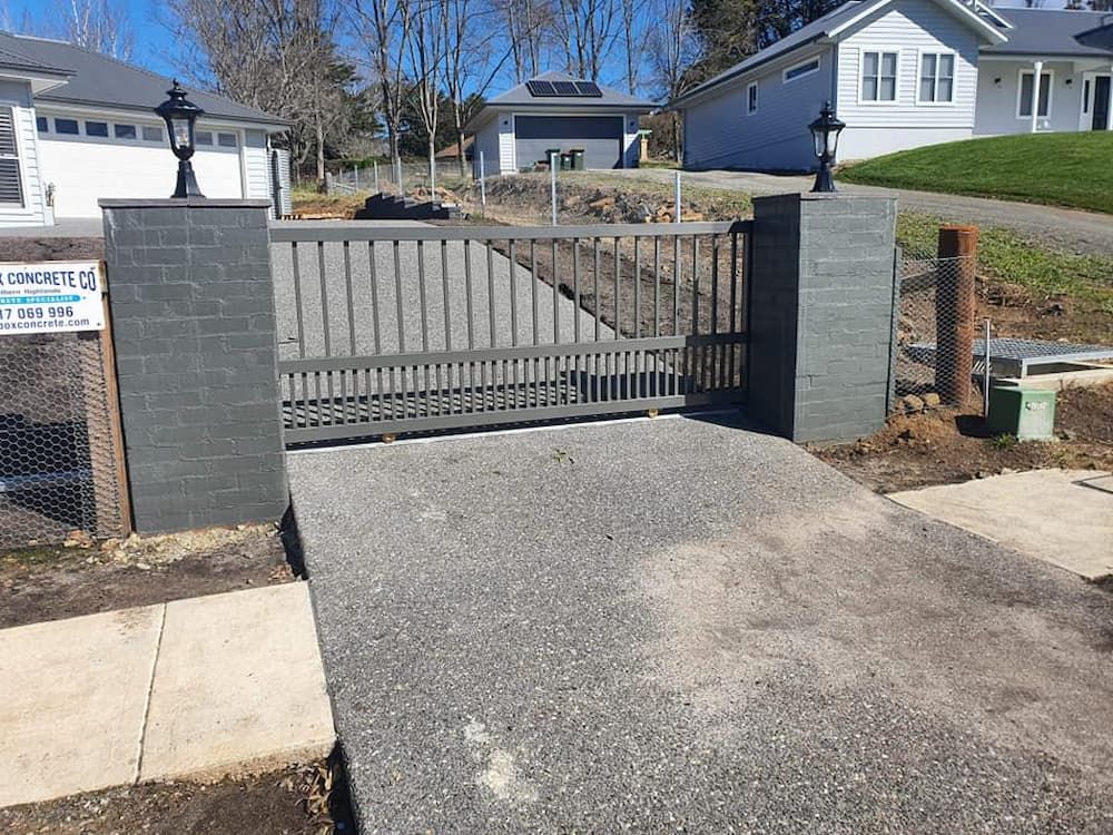 A Sliding Gate is Open to a Driveway in Front of a House — Southern Gate Automation in Mittagong, NSW