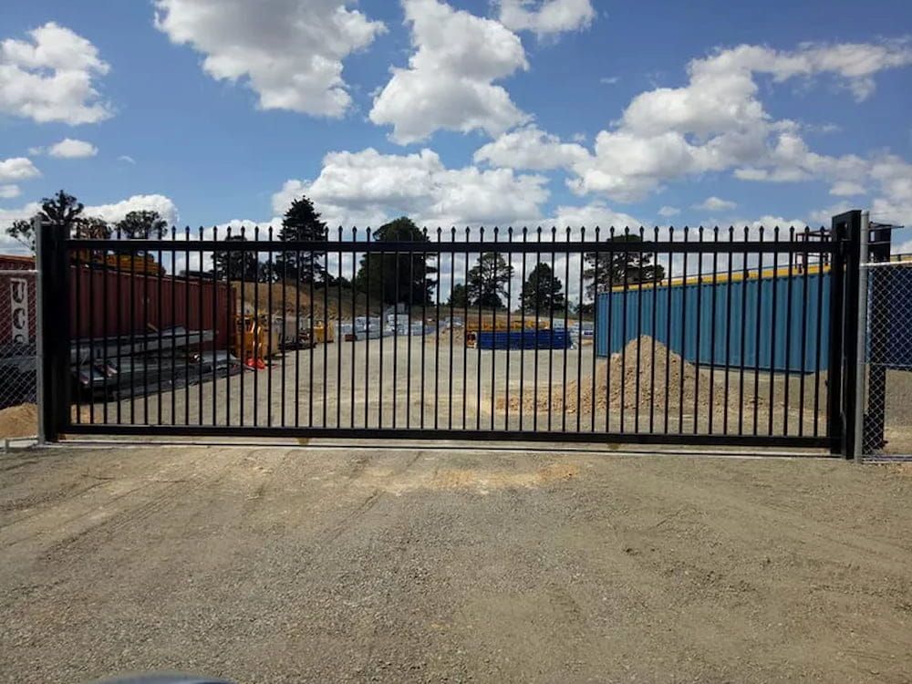 A Black Fence with a Blue Container — Southern Gate Automation in Mittagong, NSW