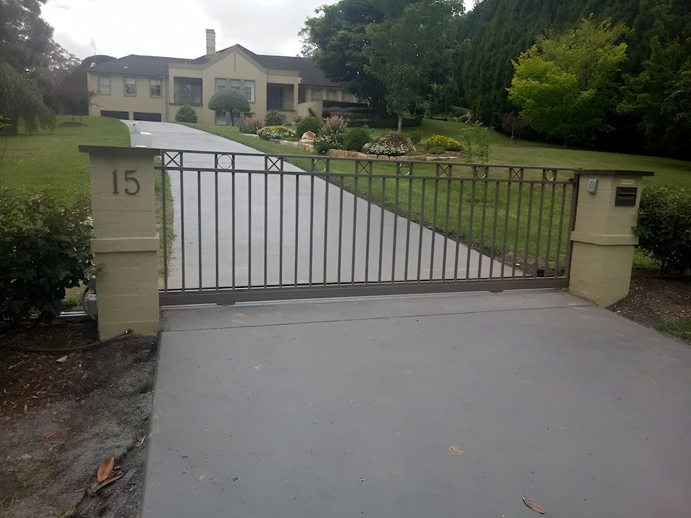 A Large House with a Driveway and a Gate in Front of It — Southern Gate Automation in Picton, NSW