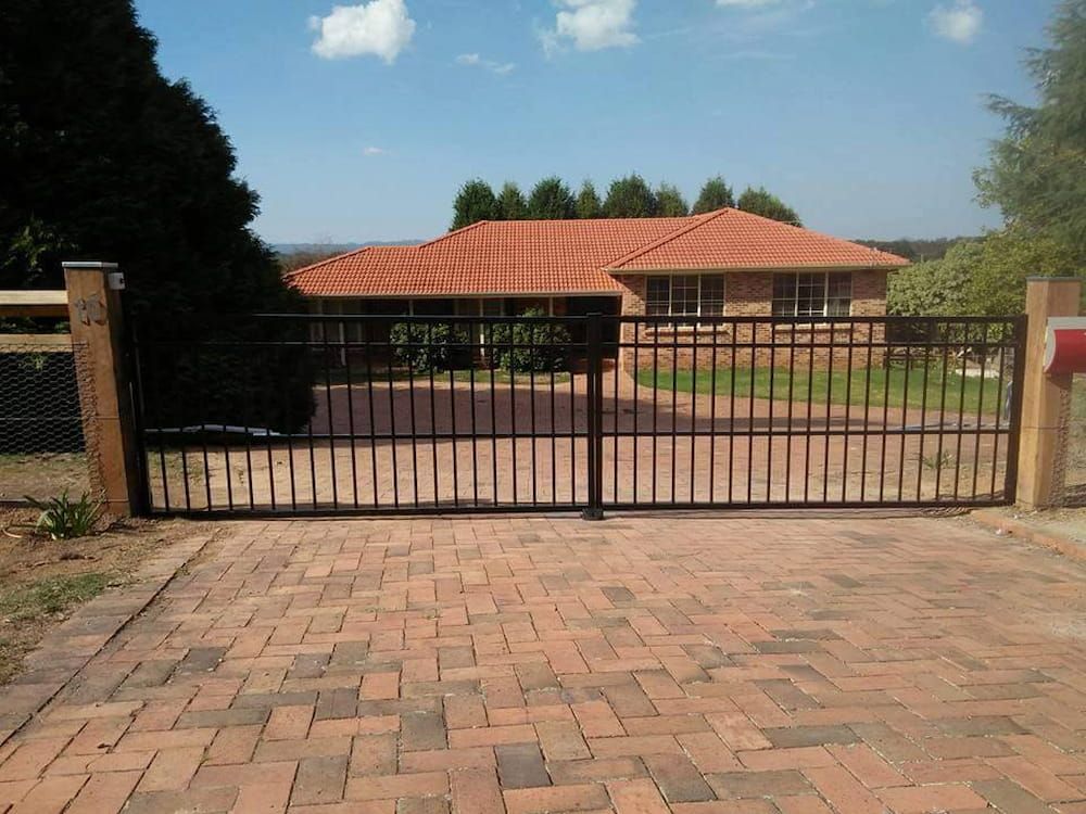 A Brick Driveway Leading to a House with a Metal Gate — Southern Gate Automation in Bowral, NSW