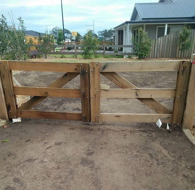 A Wooden Gate with a House — Southern Gate Automation in Picton, NSW