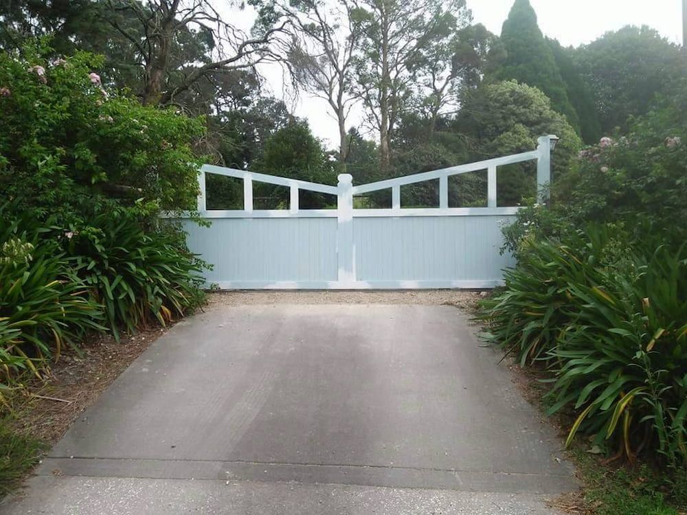 A Driveway with a White Gate in the Middle of It — Southern Gate Automation in Goulburn, NSW