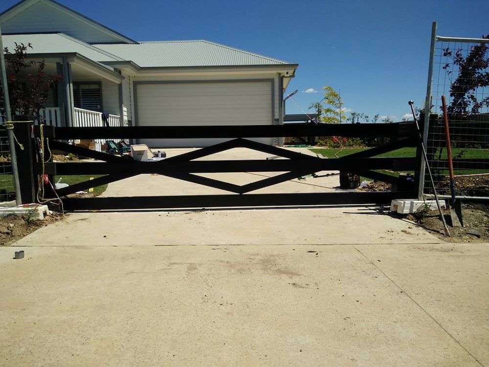 A House with a Black Gate in Front of It — Southern Gate Automation in Goulburn, NSW