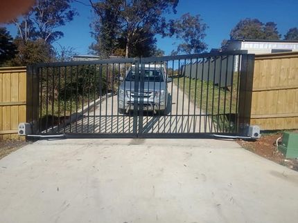 A Car is Driving Through a Gate on a Road — Southern Gate Automation in Mittagong, NSW