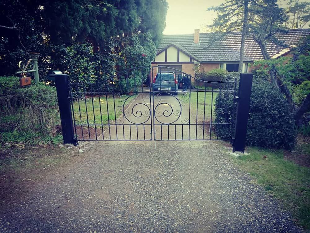 A Car is Parked in Front of a House Behind a Gate — Southern Gate Automation in Bowral, NSW