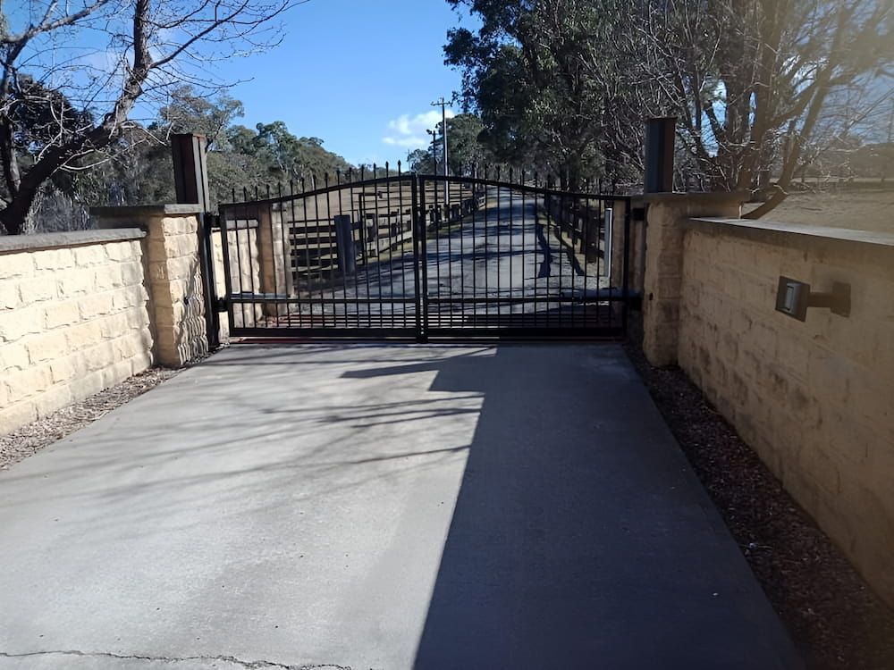 A Concrete Driveway with a Gate That is Open — Southern Gate Automation in Mittagong, NSW