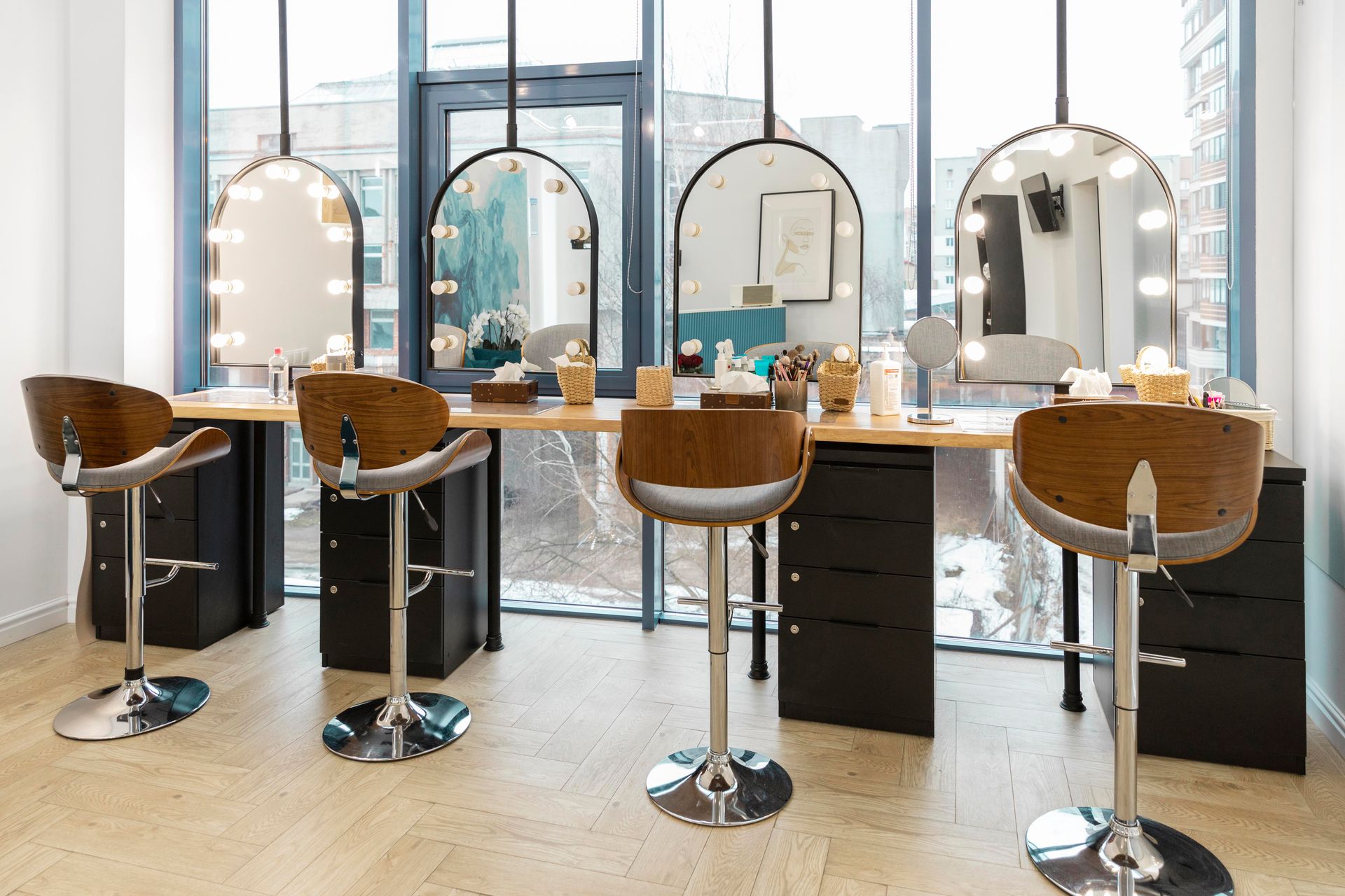 A salon with a lot of chairs and mirrors.