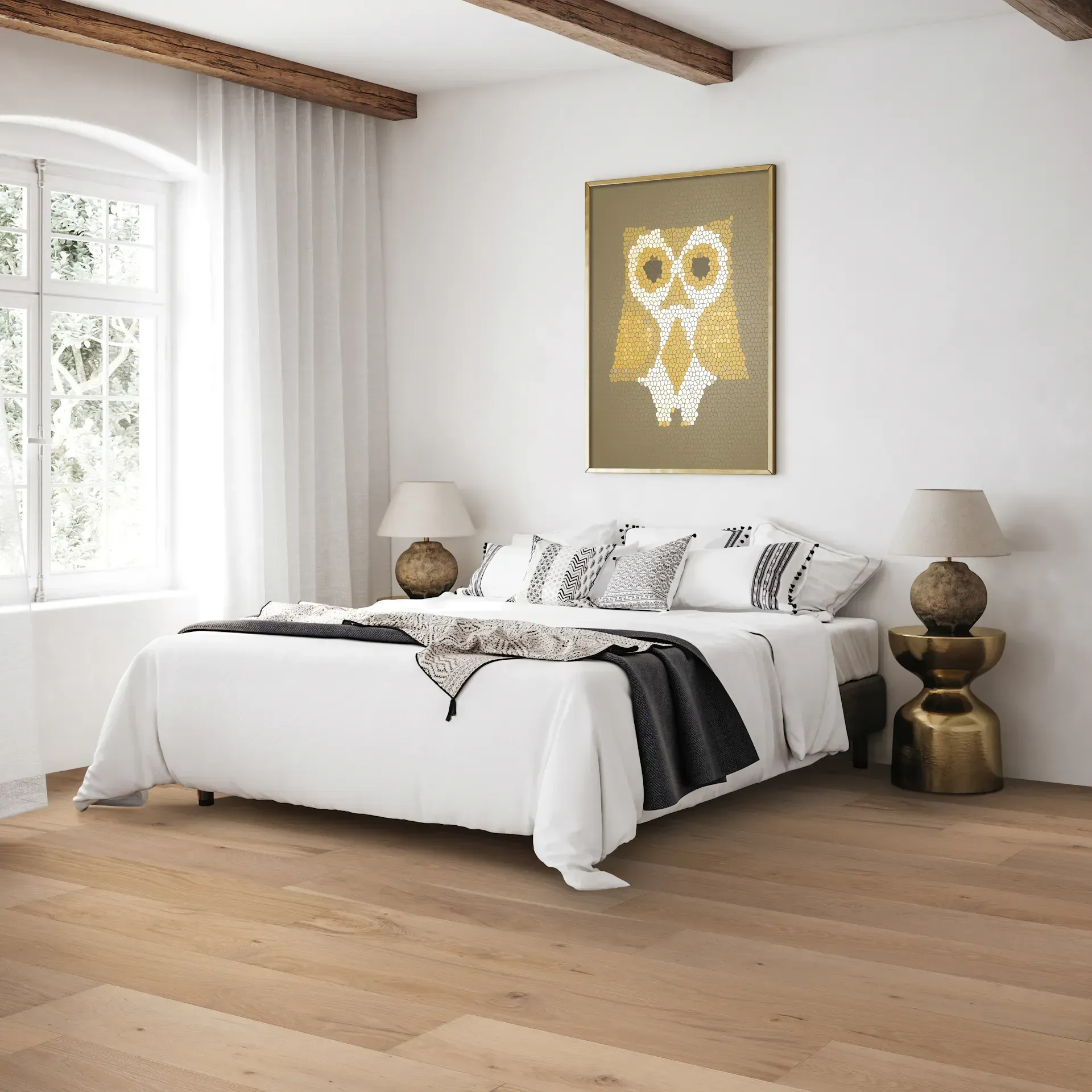Bedroom with white bedding, owl art, and light wood floors.