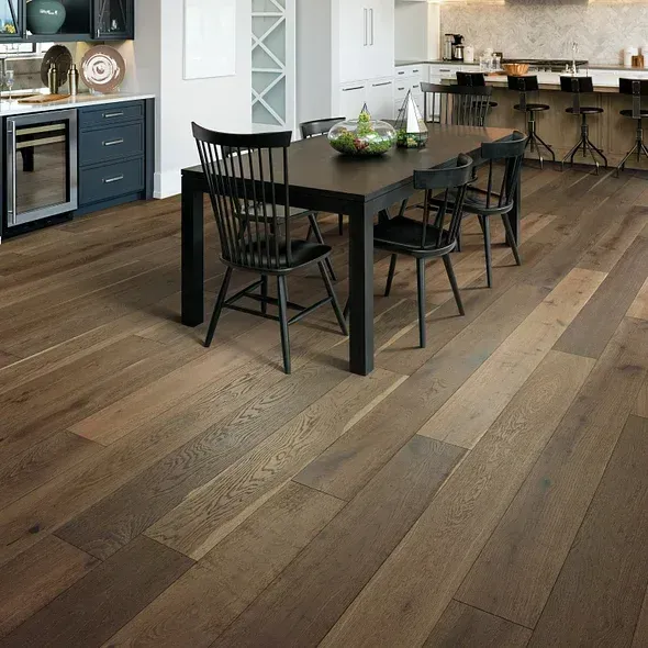 Hardwood floor in a kitchen with dining table and chairs; dark wood, neutral colors.