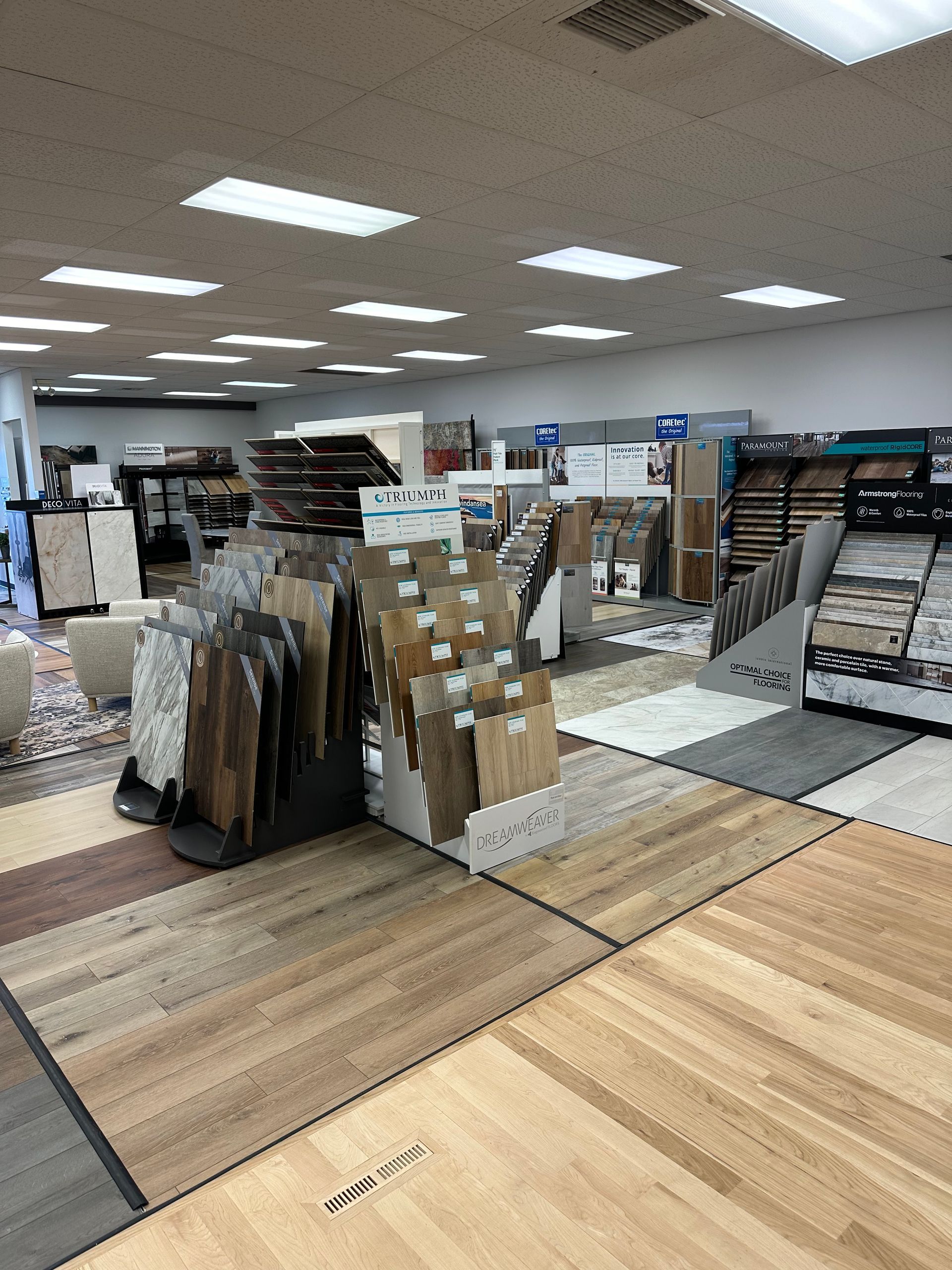 Interior of a tile store with various flooring samples on display.