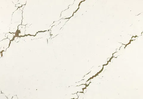 White surface with gold veining, resembling marble.
