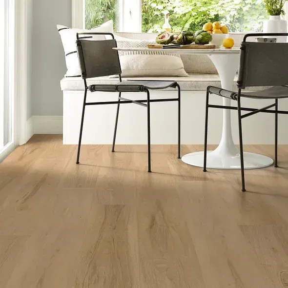 A dining room with a table and chairs and a window seat.