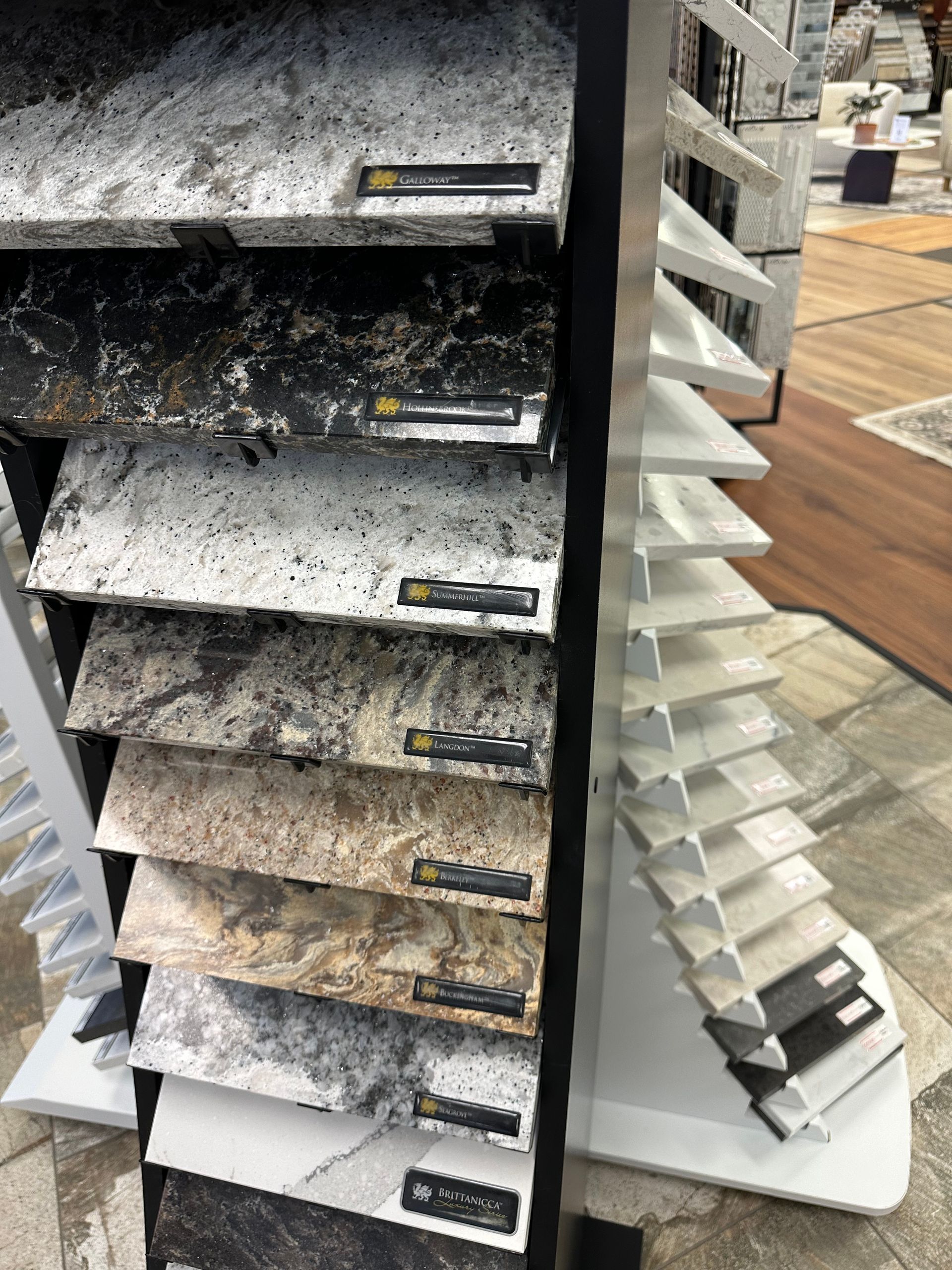 Samples of stone countertops displayed on a rotating stand, showcasing various colors and textures.