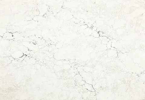 Off-white stone surface with subtle gray veining, suitable for countertops or flooring.