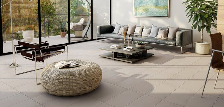 A modern living room with a sofa, coffee table, and outdoor view.