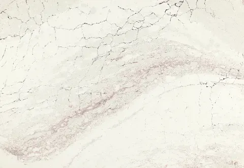 Creamy white marble surface with subtle pink veining and fine dark crack lines.