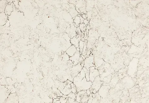 Cream-colored countertop with dark veining, creating a marble-like pattern.