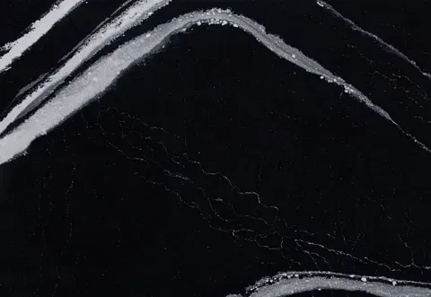 Black countertop with bold, silver-white veining.