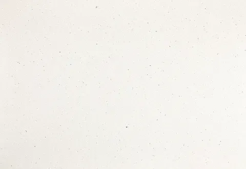 Off-white wall, slightly textured, with small dark specks.