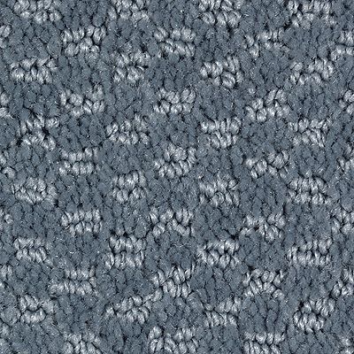 Blue and gray patterned carpet with a textured floral design.