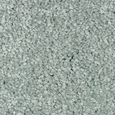 Close-up of light blue carpet with a speckled texture.