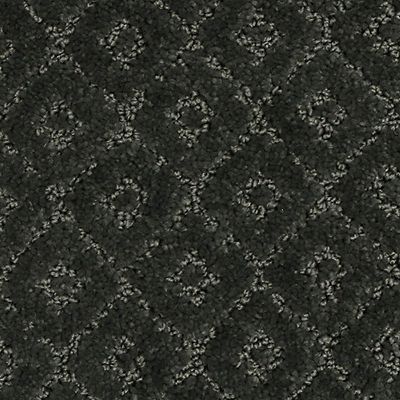 Dark gray patterned carpet with diamond and floral designs.