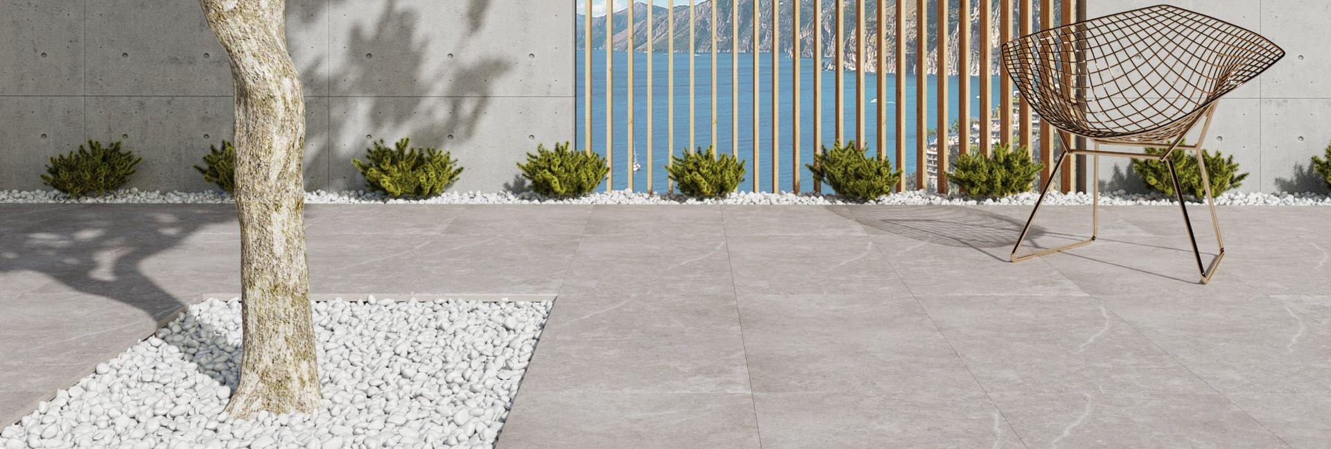 Exterior patio with tree, bushes, and a woven chair.