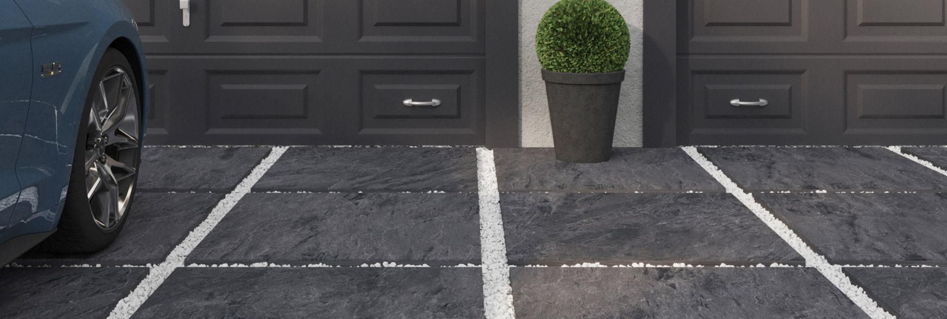 Blue car parked in a parking space in front of a garage door. A plant pot sits in the middle.