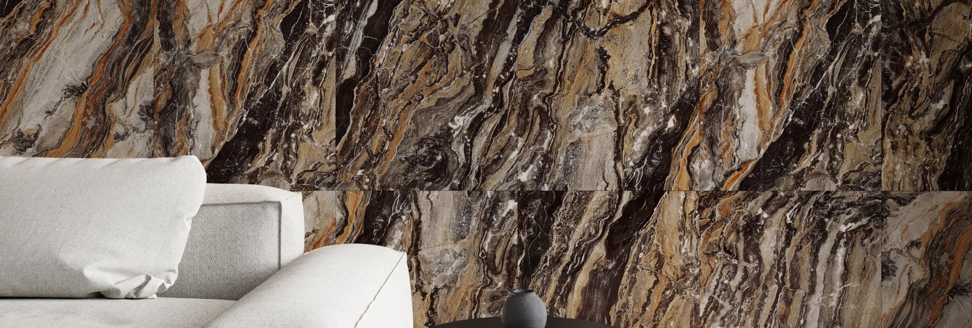 A living room with a white sofa in front of a stone accent wall.