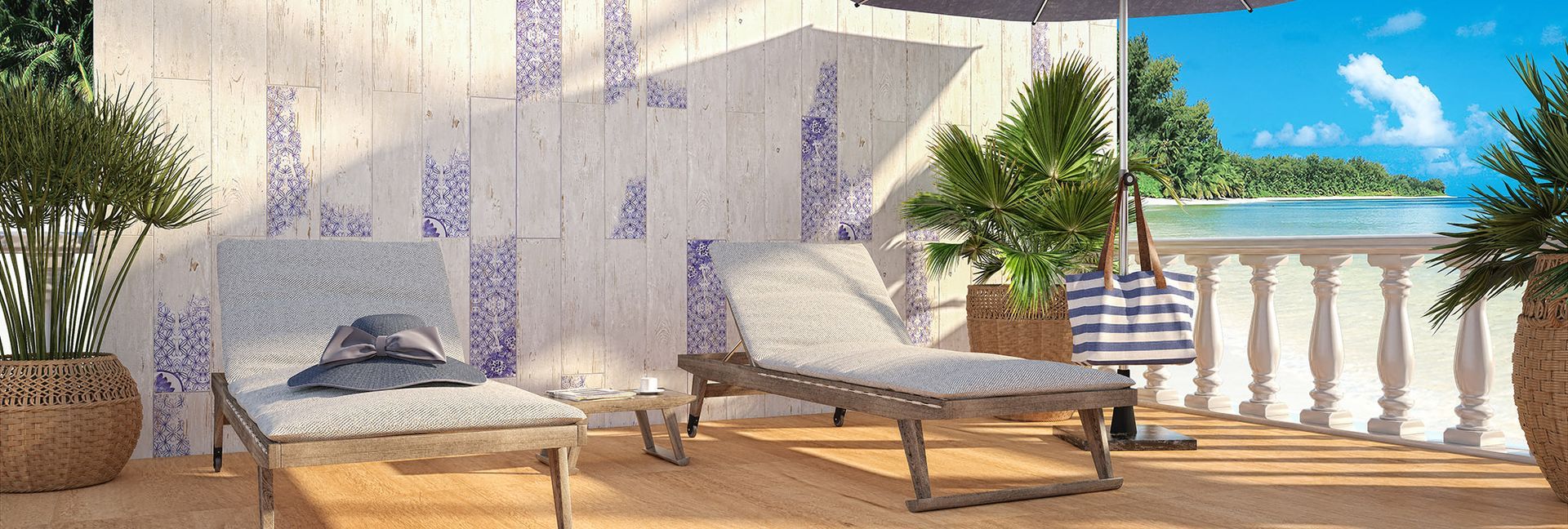 Two lounge chairs on a sunny balcony with a view of the ocean.