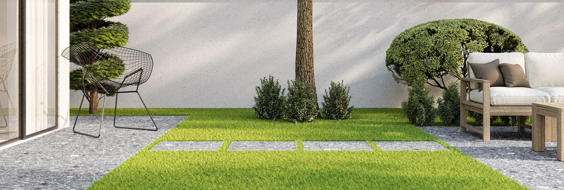 Outdoor patio with green grass, stone path, a tree, bushes, and a white couch.