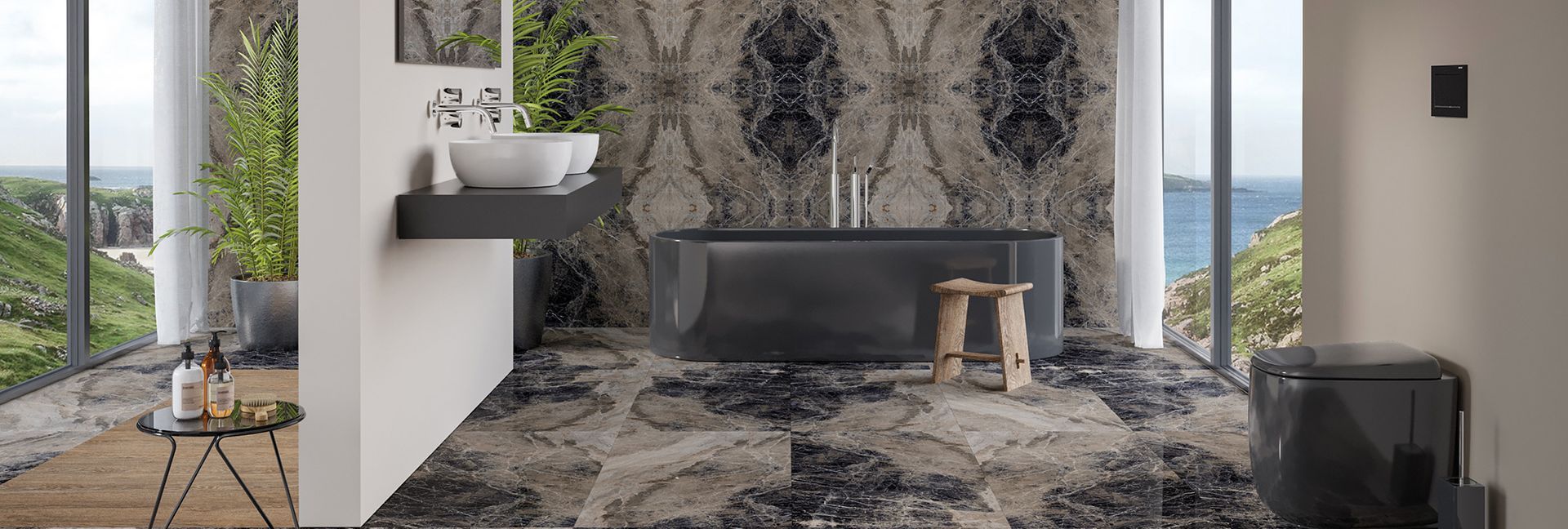 Bathroom with patterned tile, black tub and sink, and view of the ocean.