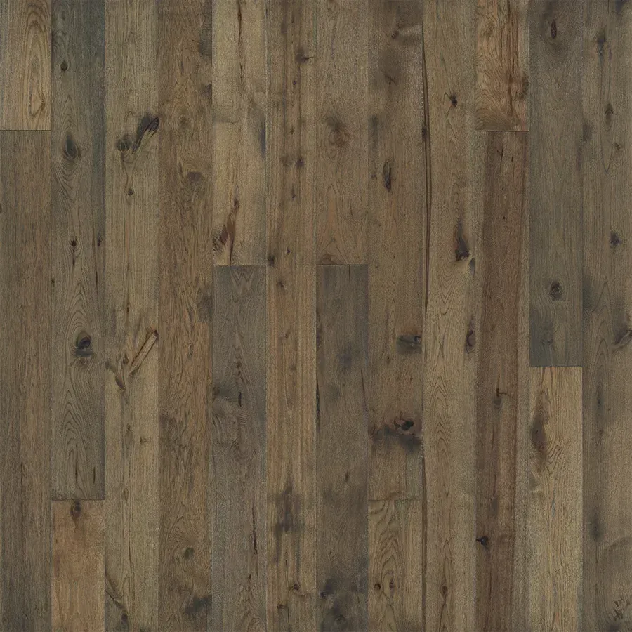 Dark, weathered wooden floor planks with varying shades of brown and grey.