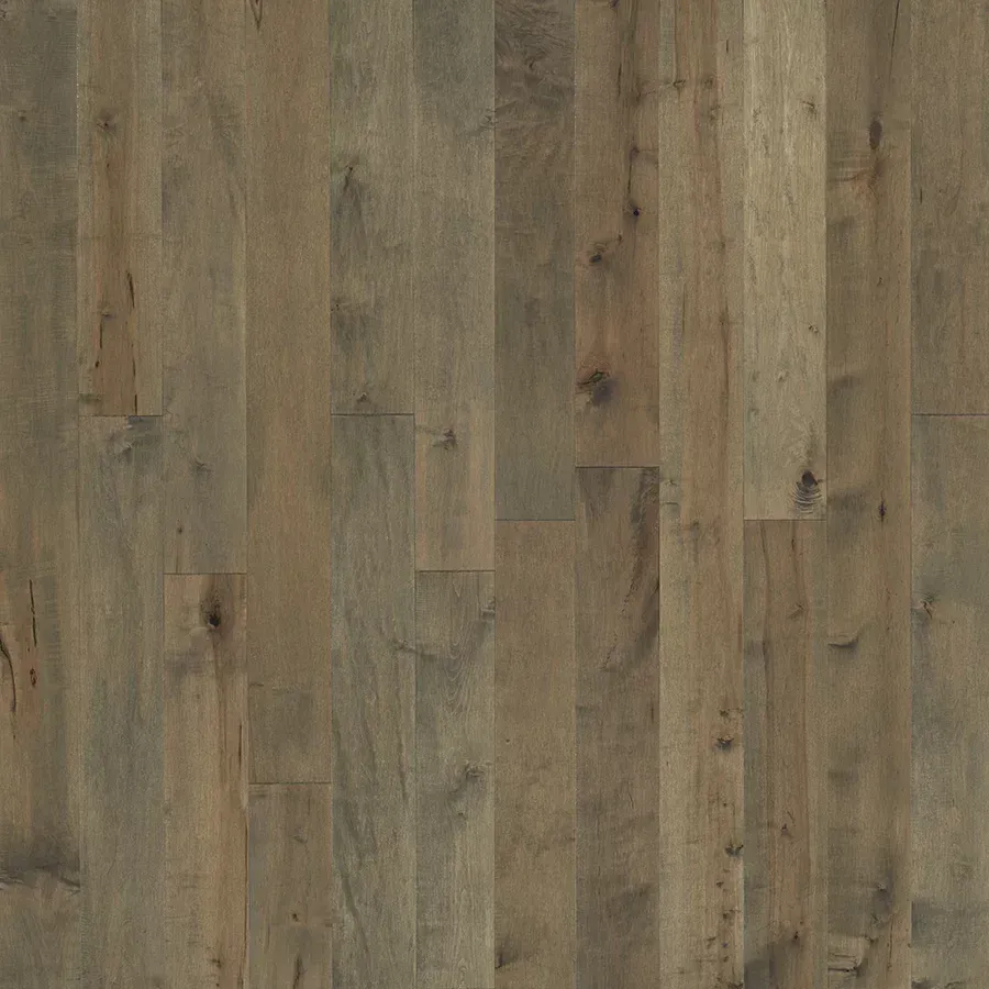 Wood flooring with varying shades of gray and brown planks.