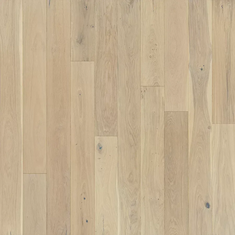 Light-colored hardwood floor with varied wood grain and knots, in shades of beige and gray.