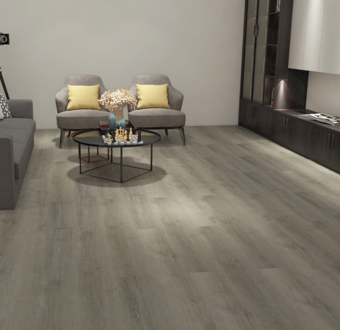 Living room with gray wood-look flooring, gray furniture, yellow pillows, and a black coffee table.