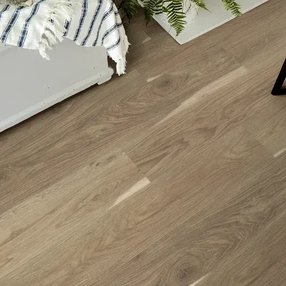 Light brown wood-look flooring with a portion of a white table and a blue and white striped cloth.